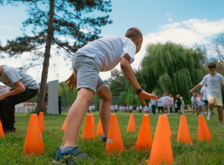 Group of kids enjoying exercise and play at a park obstacle course.